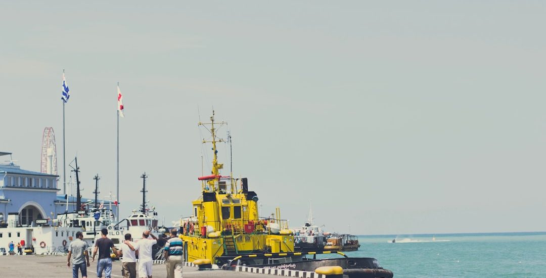 yellow and black heavy equipment on dock during daytime