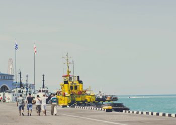 yellow and black heavy equipment on dock during daytime