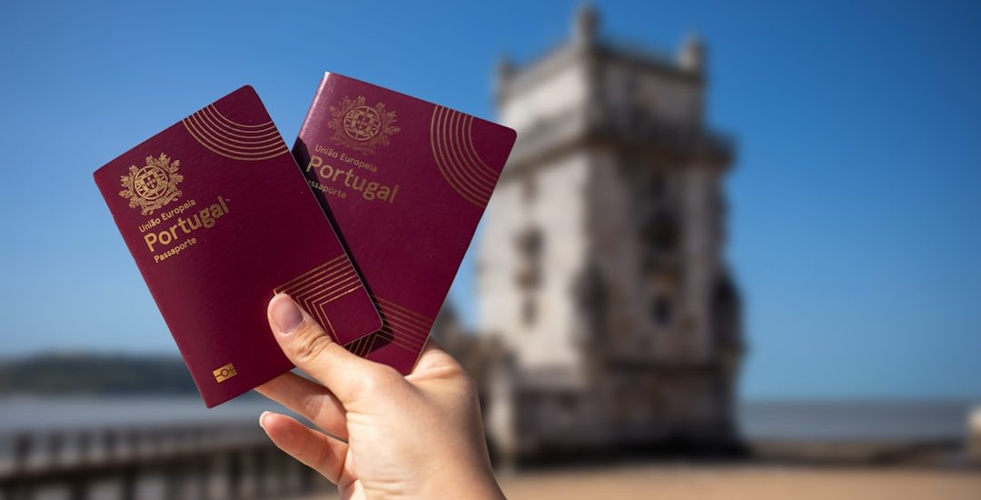 Holding two portuguese passports with a tower.